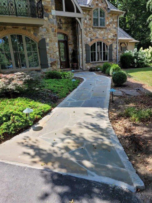 a stone walkway leading to a front door